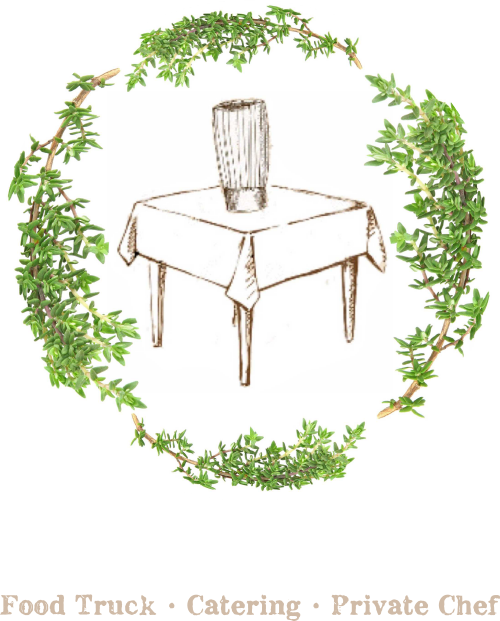 Table with vase surrounded by greenery