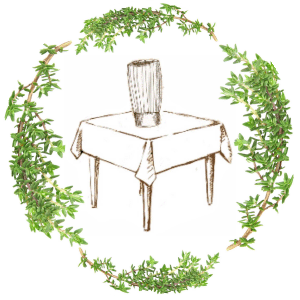 Table with vase surrounded by greenery